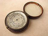 19th century pocket barometer with curved thermometer, in case.